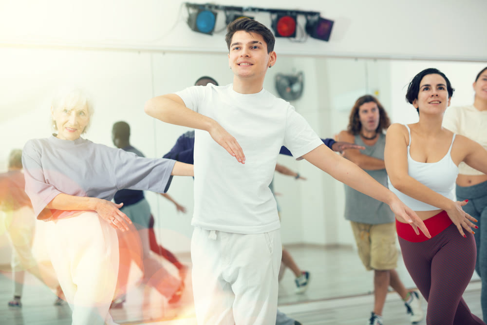Group of adult people practices dance aerobics