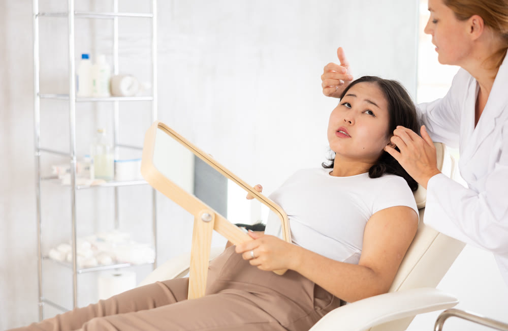 Asian woman listening to professional medicine worker