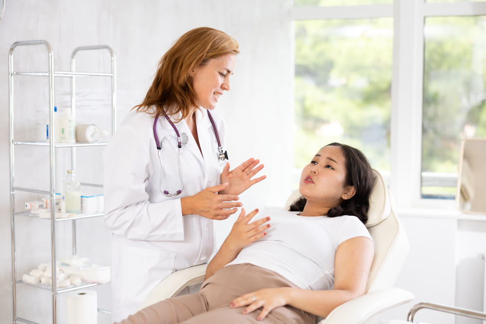 Woman cosmetician talking with woman before procedure in aesthetic cosmetology clinic
