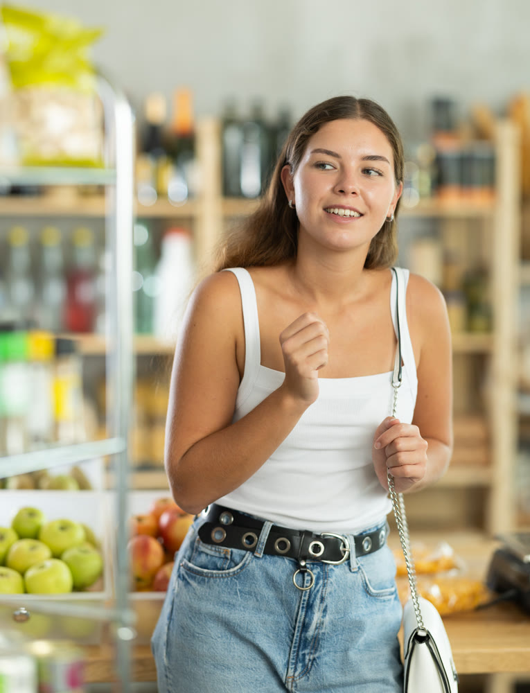 Female shopper chooses fresh produce in grocery supermarket