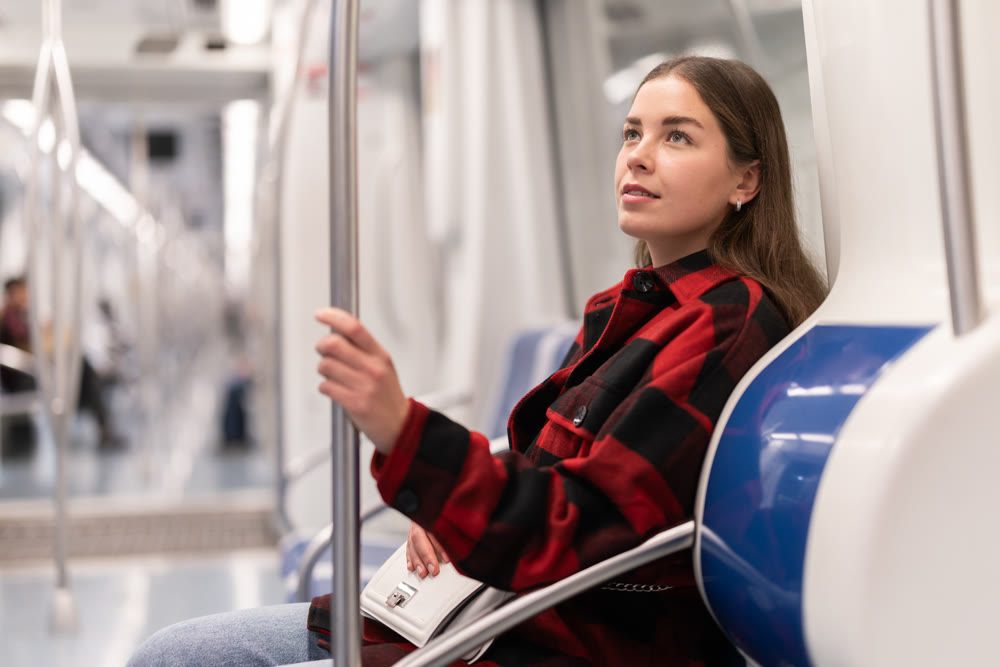 Girl sit in tram car, getting to work