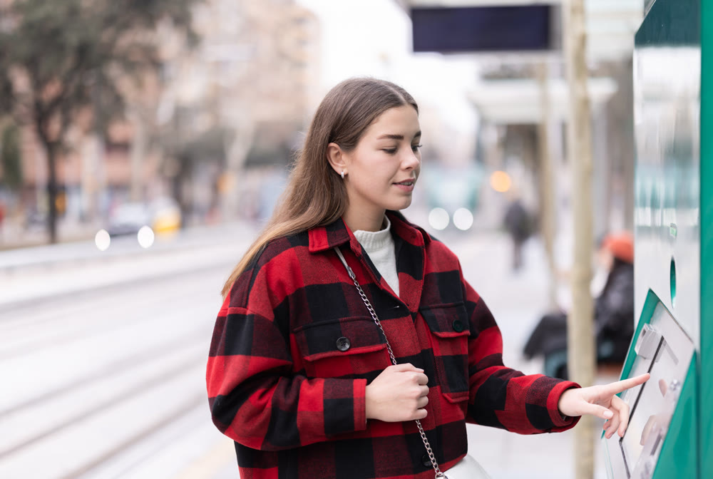 girl pays for a tram fare
