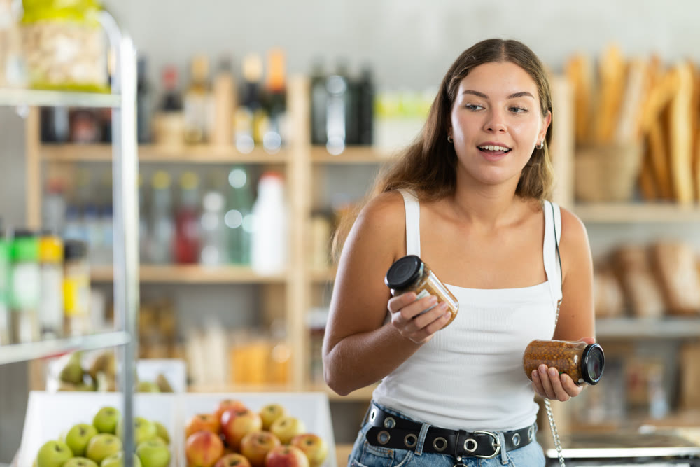Young woman choosing lentils in grocery store