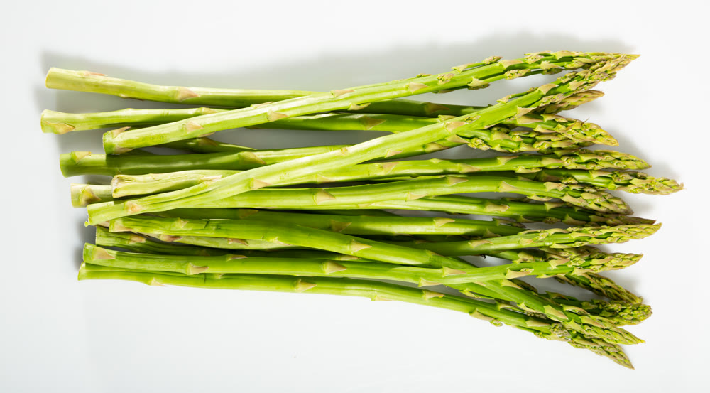 Raw fresh green asparagus isolated on a white background