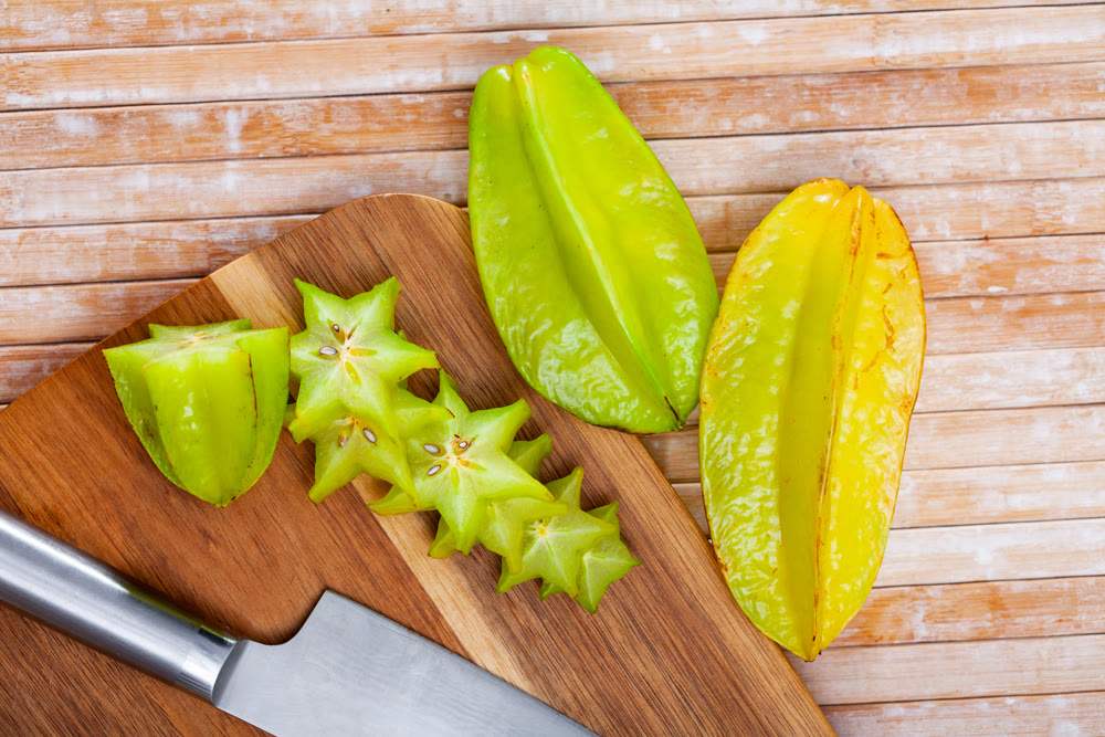 Carambola fruit on wooden table closeup