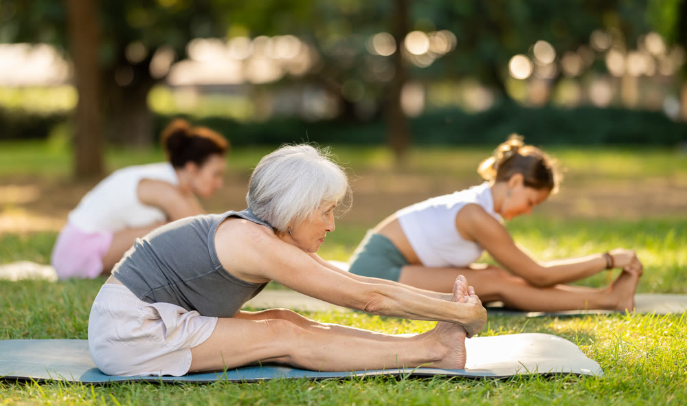 Elderly woman stretching in park