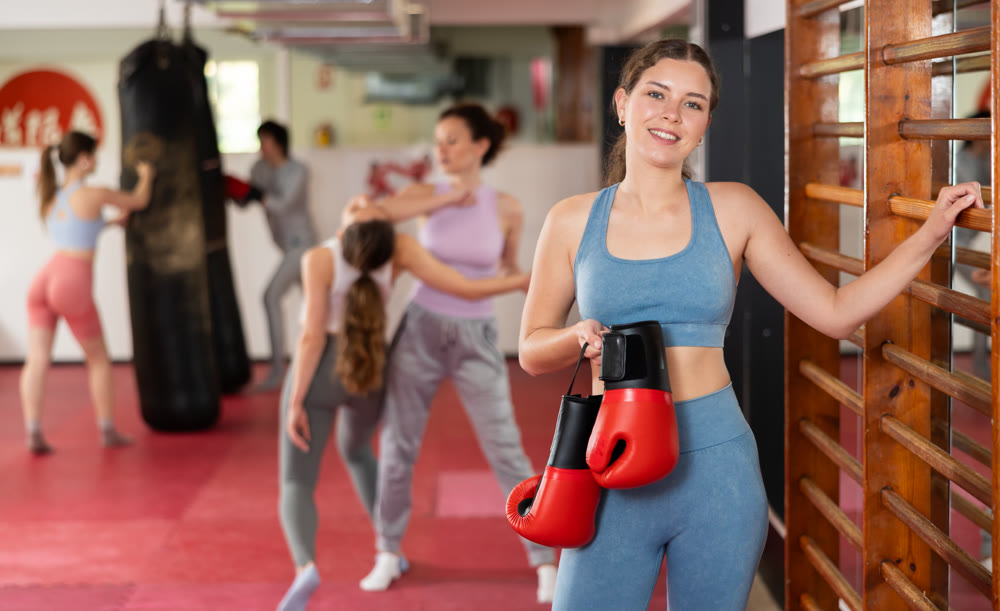 Young woman with boxing gloves during training
